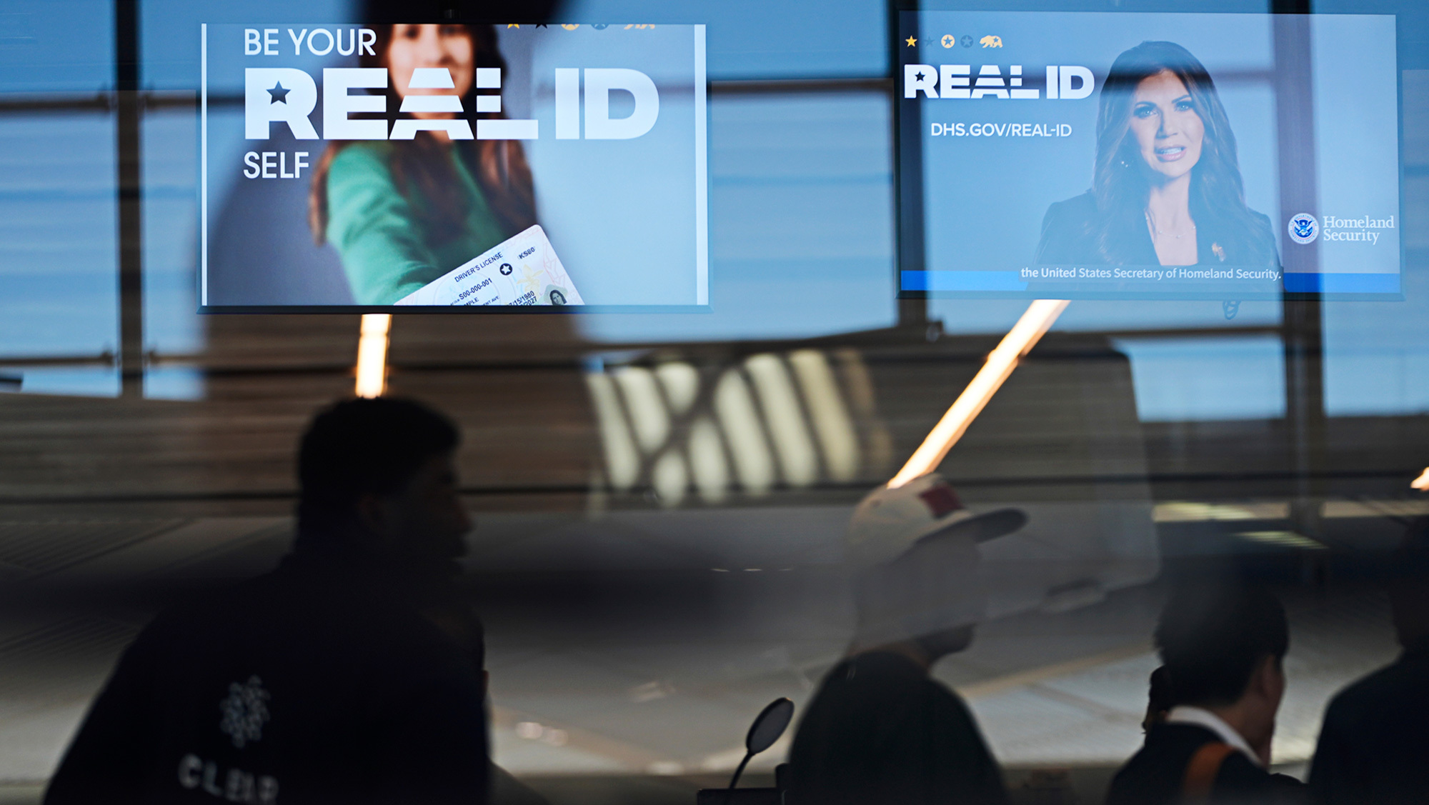 A news photo from an airport showing Real ID signs for travelers