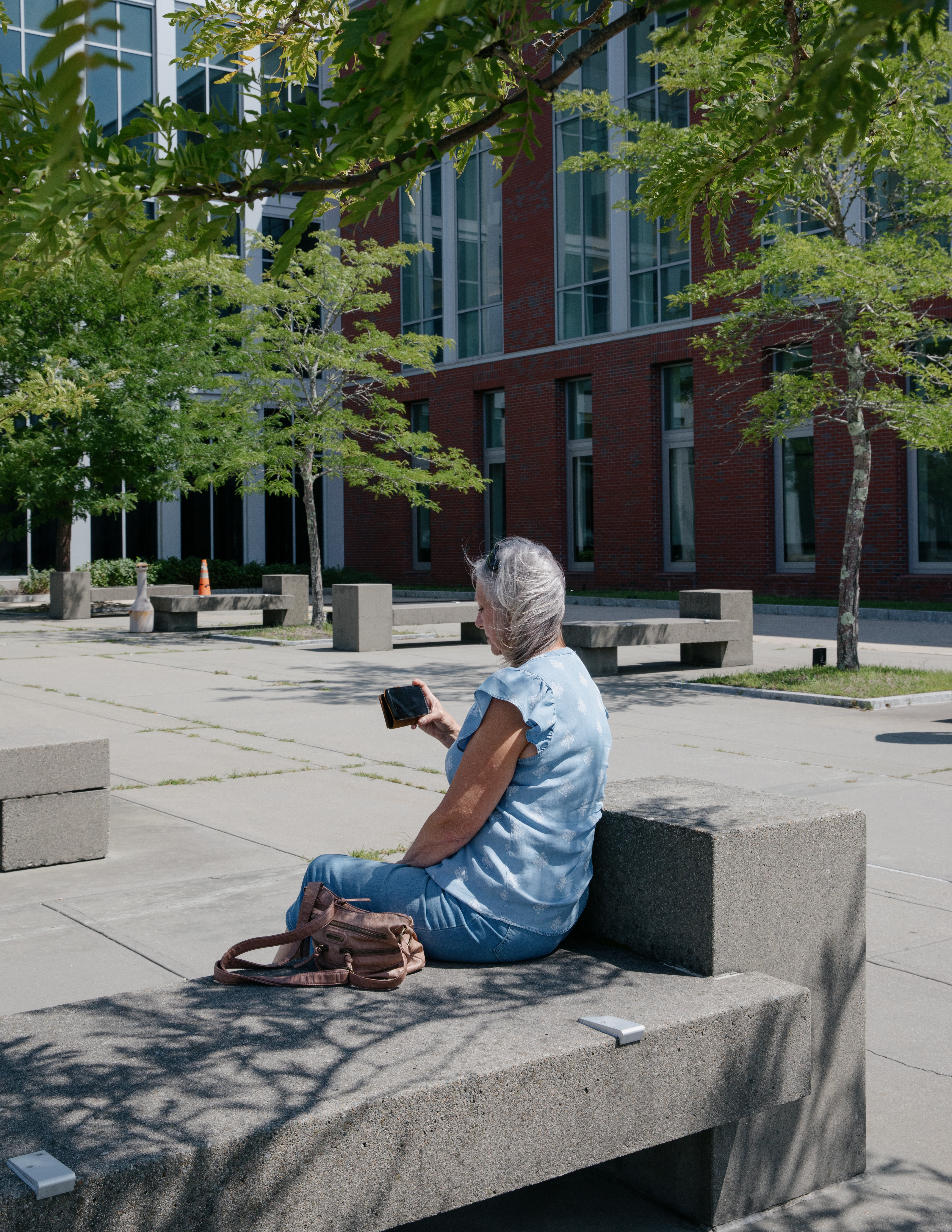 A picture of Debbie Haskins watching the Lindsay Clancy trial on her phone