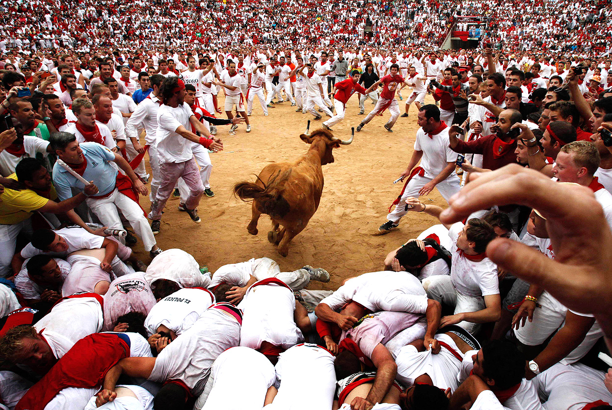 A participant runs ahead of bulls during the encierro of the San News  Photo - Getty Images