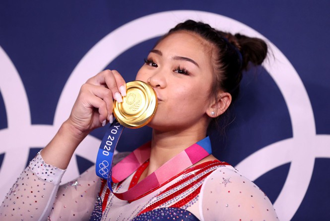 Sunisa Lee of the U.S. gymnastics team kisses her gold medal