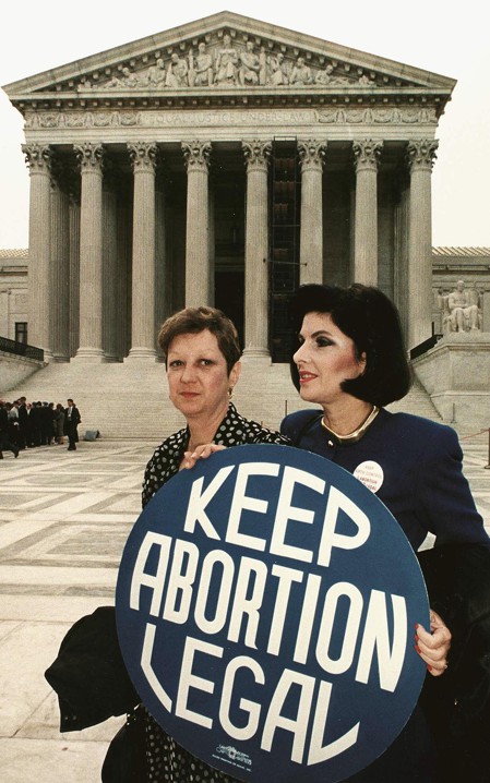 A photo of McCorvey with attorney Gloria Allred in front of the U.S. Supreme Court, 1989