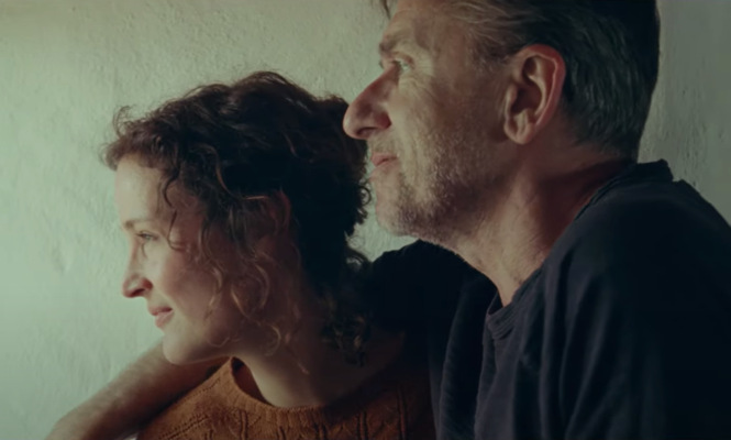The central couple from "Bergman Island" looks into the distance.