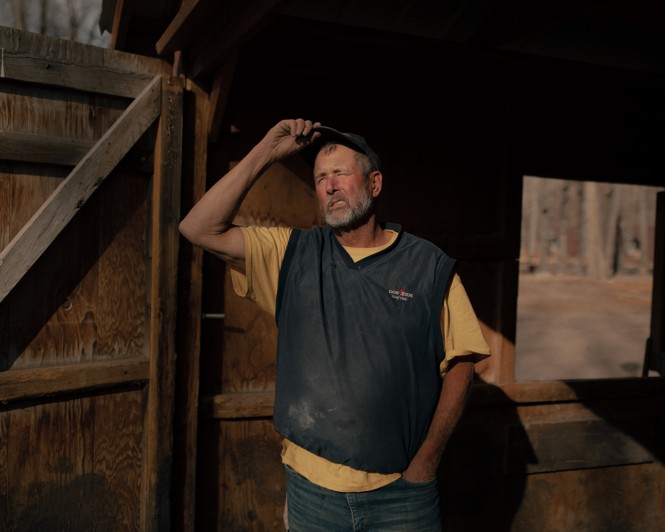 Portrait of Dave Taylor outside a stable.