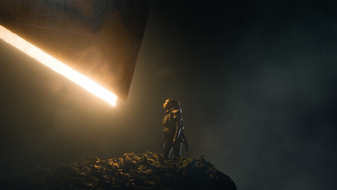 A scene from 'Foundation' where a uniformed person looks up at a streak of light.