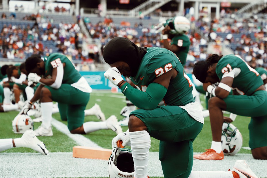 A prayer kneels before a game between Florida's A&M Rattlers and Bethune Cookman's Wildcats in Orlando, Florida.