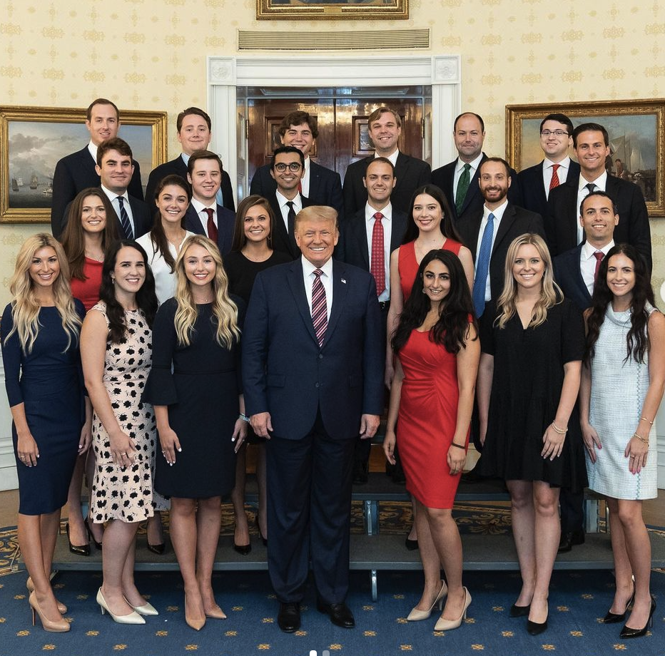 Trump standing with members of his office.