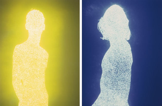 Two silhouetted figures filled with glowing points of light