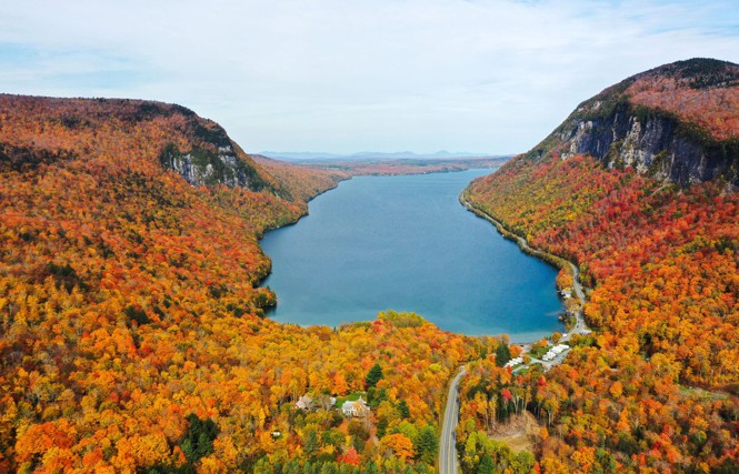 Orange leaved trees surround a lake in Vermont