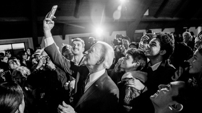 Joe Biden takes a selfie with a crowd.
