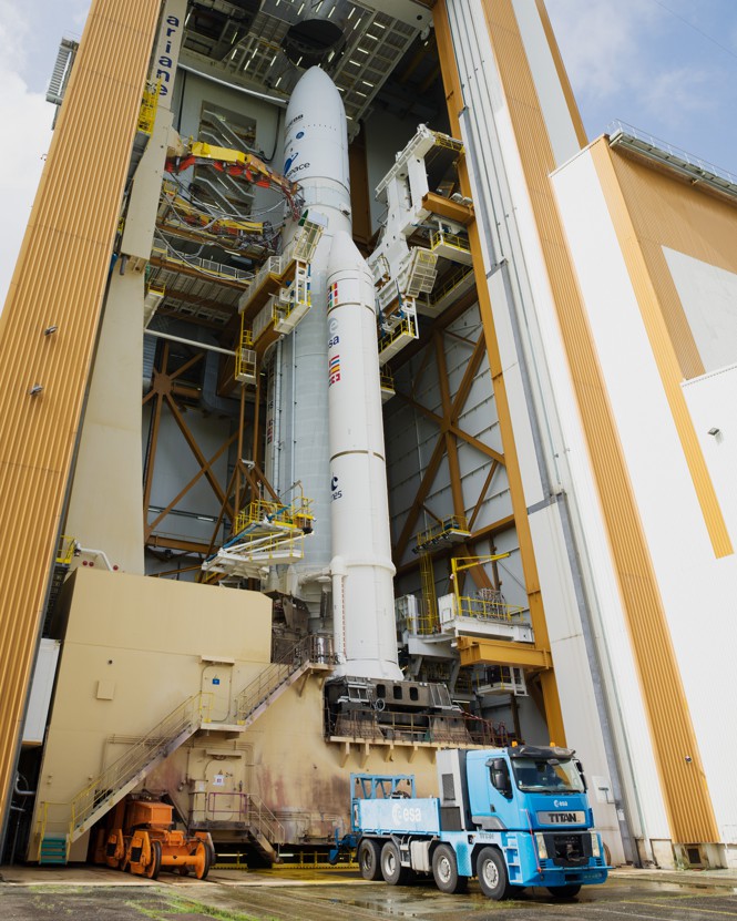 The Ariane 5 rocket, with the James Webb Space Telescope perched on top, is pictured along with the small blue truck that transported it to the launchpad.