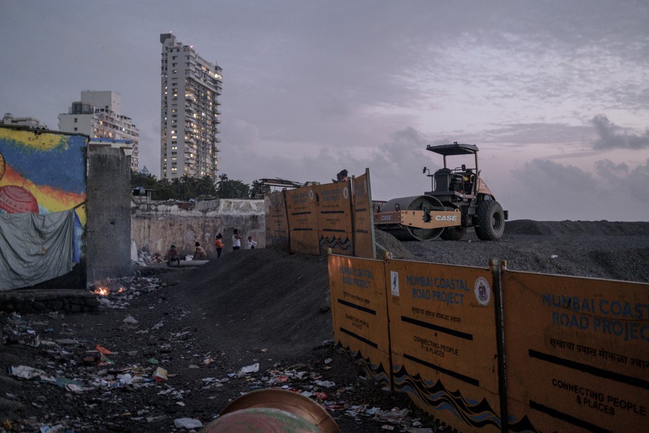 Local residents amongst the newly reclaimed land and construction material from the ongoing Coastal Road project.