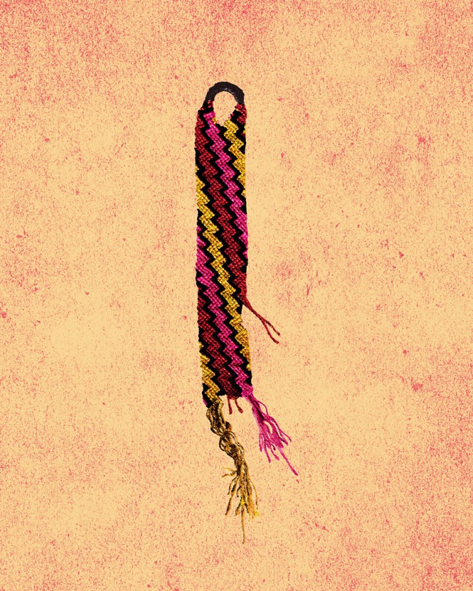 a hand-knotted friendship bracelet with yellow, pink, red, and black zigzags that has frayed and broken
