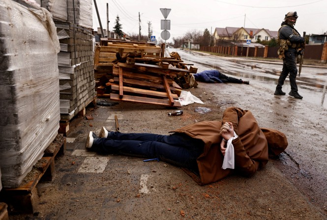 A Ukrainian person on the ground with their hands tied