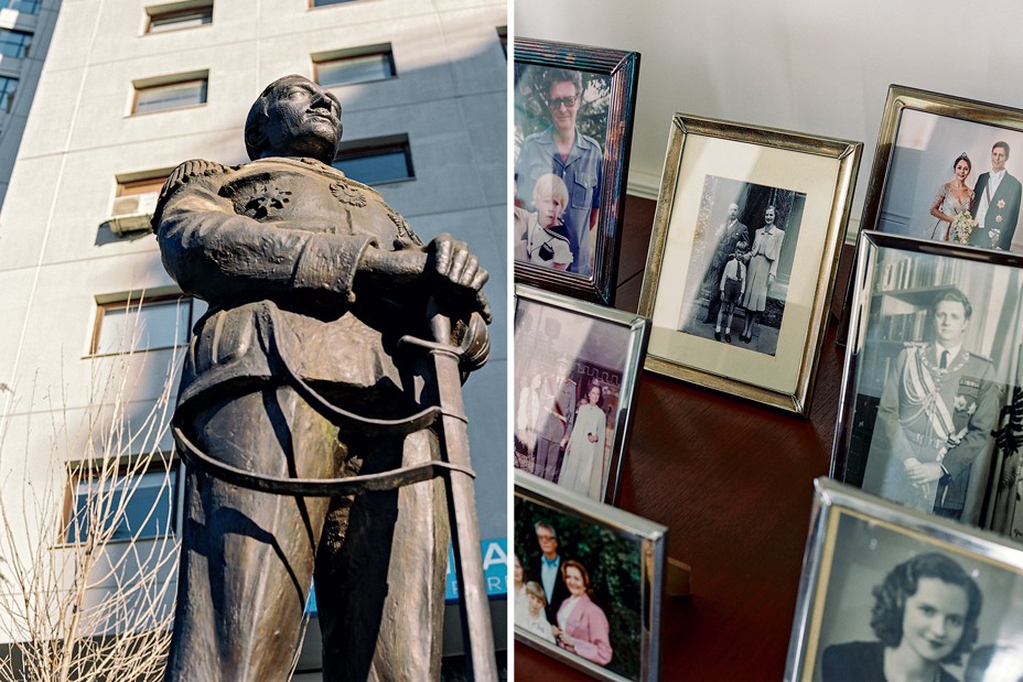 2 photos: statue of man standing in uniform clasping the hilt of a sword resting on ground; set of family photos in frames