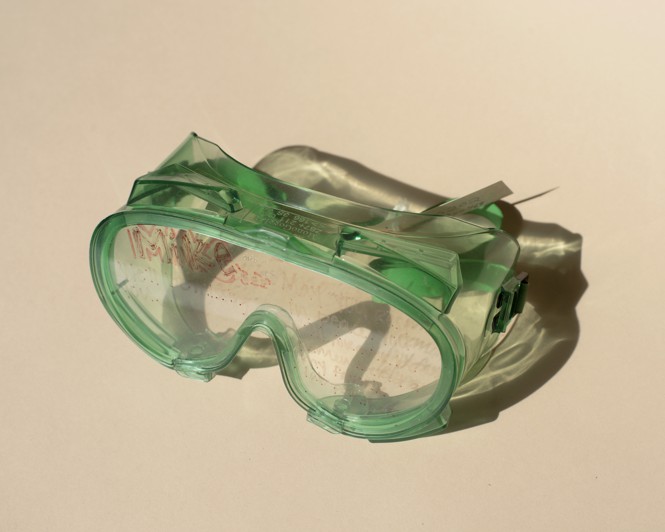 green lab goggles with a boys name written in red