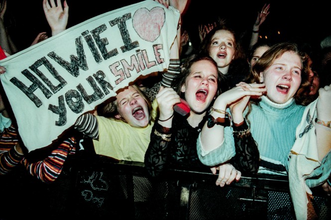 Photo of young fans screaming for the Backstreet Boys at a show in 1996