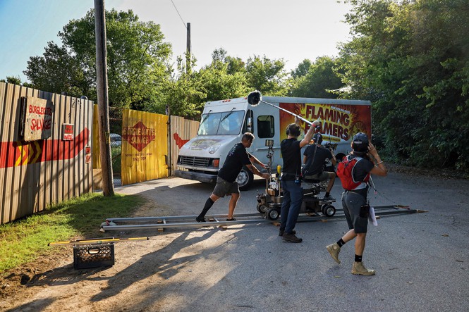 photo of a set with camera crew filming a white truck with Flaming Flamers on the side