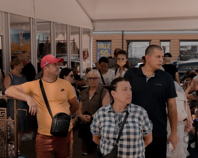  a group of people standing in line outside
