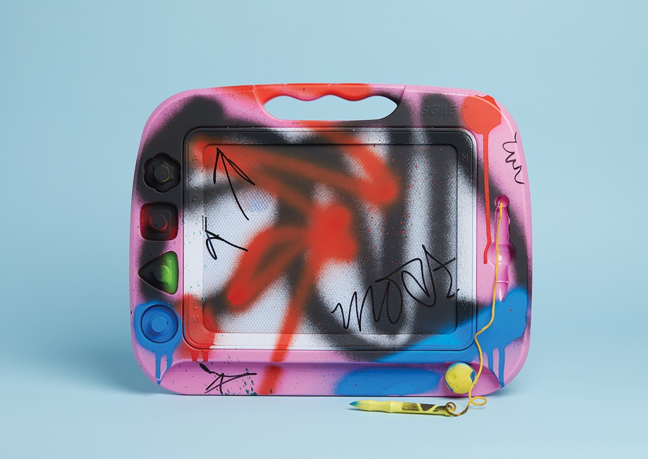 photo-illustration of child's drawing tablet covered in spray paint