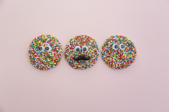 three nonpareils with faces on them