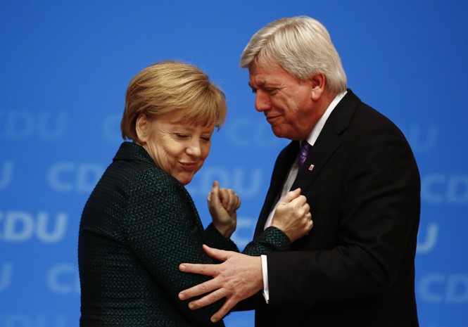Volker Bouffier touching Angela Merkel's elbow