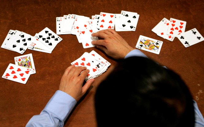 A person sorts a deck of cards.