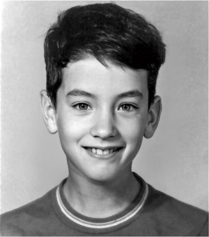 black-and-white school portrait photo of smiling boy with short dark hair