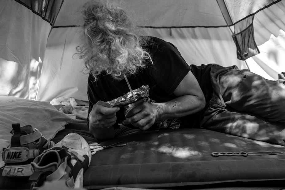  a person smoking in a tent