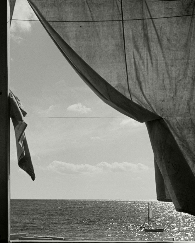 A window looks out into the sea