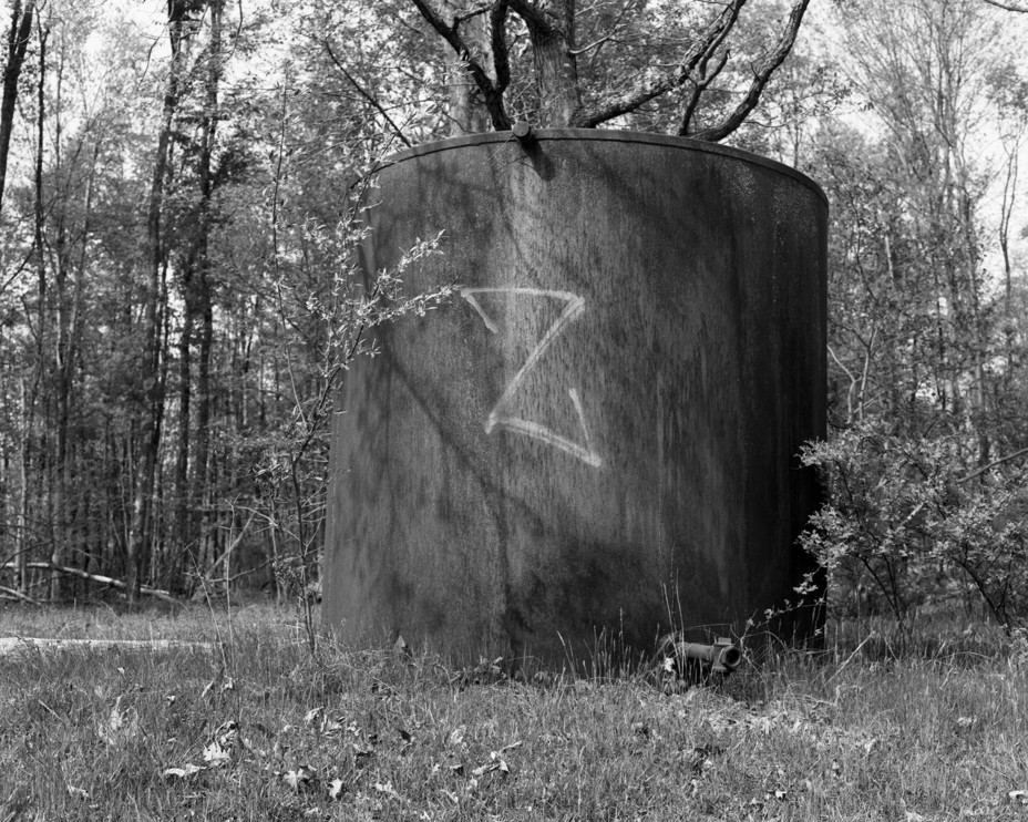 BW image of a water tower with the letter Z painted on it