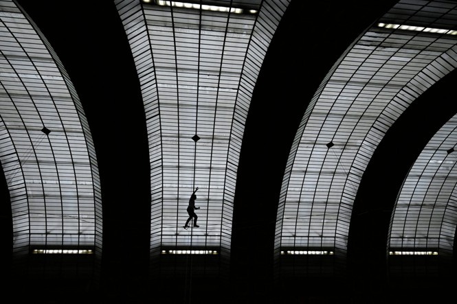 French tightrope walker Nathan Paulin walks on a wire during a performance of 