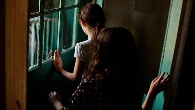 Two girls leaving a house