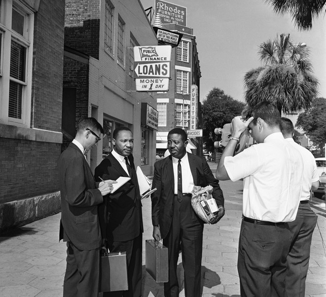 Martin Luther King, Jr., second from left, talks to a newsman on July 12, 1962 in Albany, Georgia