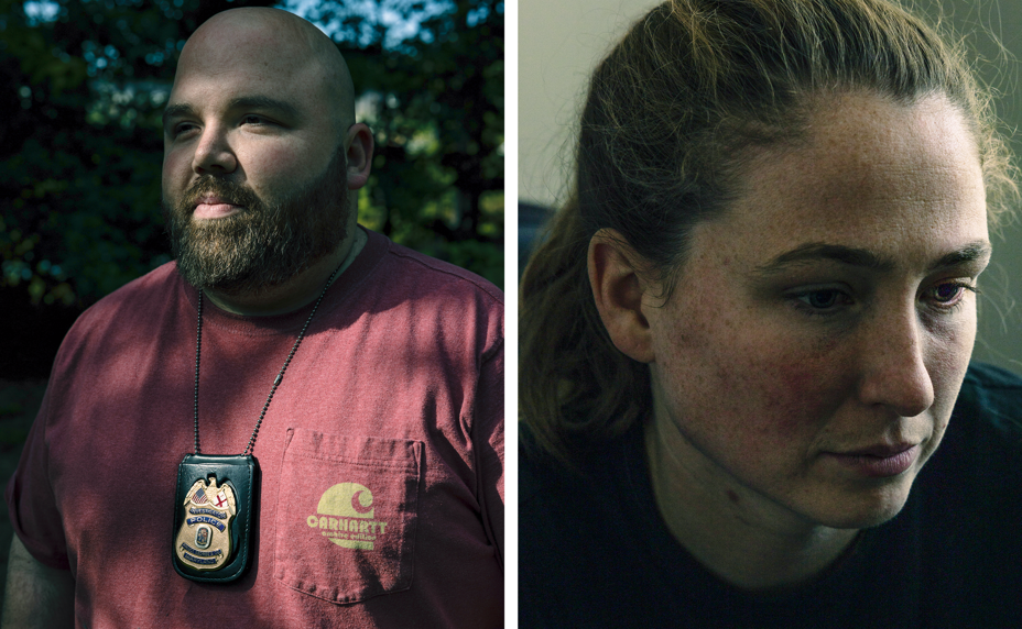  man with shaved head and beard wearing red t-shirt and police badge around neck; woman looking to side with hair pulled back in ponytail