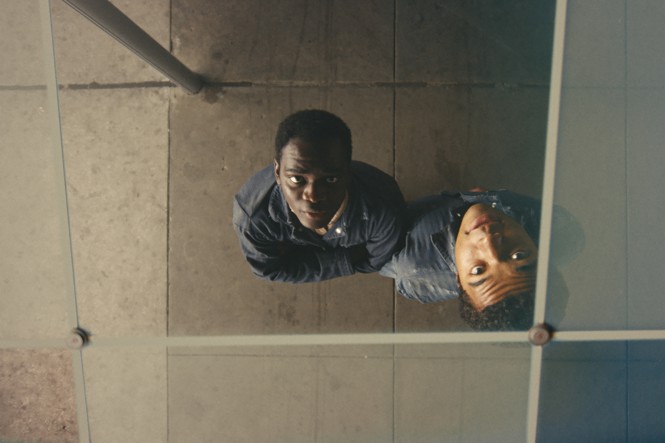 Two young men are seen looking up