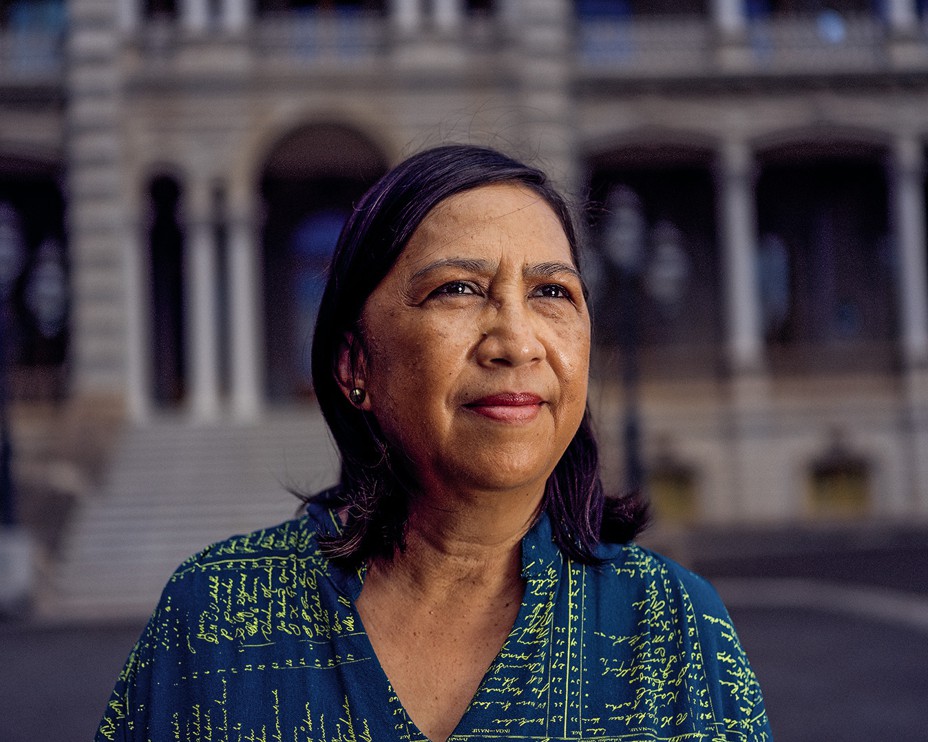 photo of woman with shoulder-length hair with columned building in background