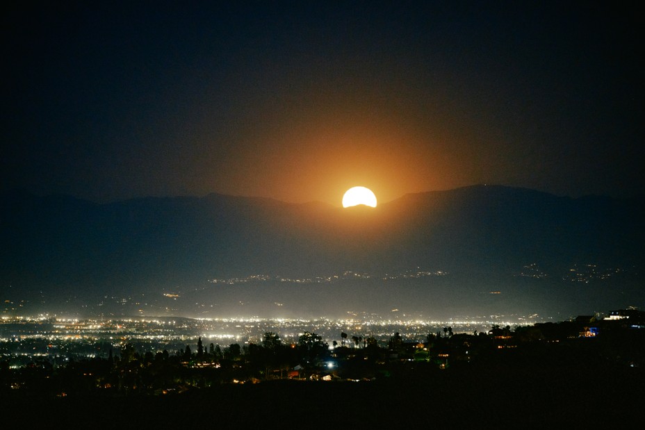 Sun setting over a dark Los Angeles