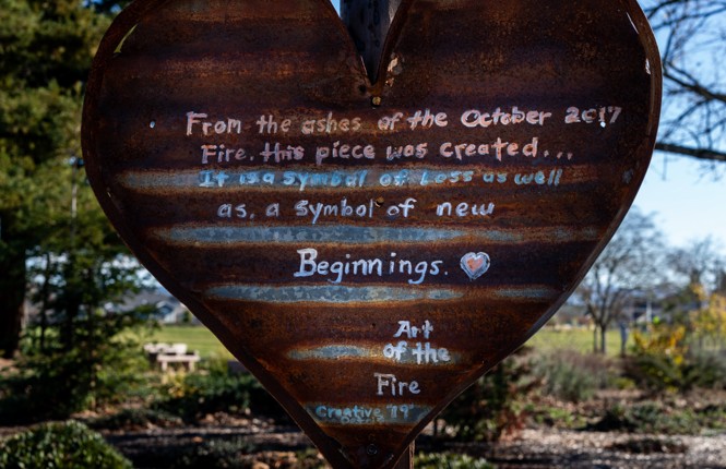 Photo of a metal heart with a poem about rebuilding after the October 2017 Fire.