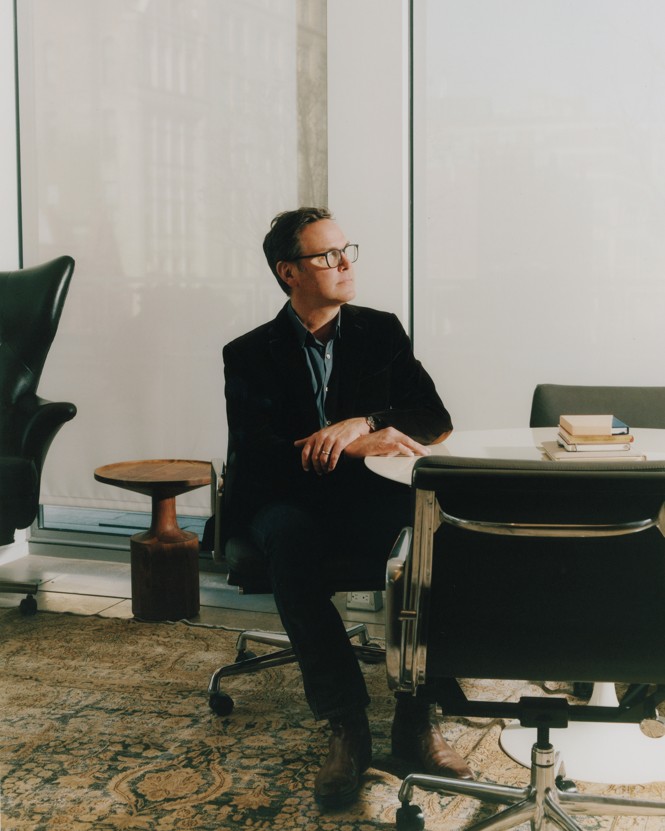 James Murdoch steated at a white table at the offices of his investment firm, Lupa, in New York City