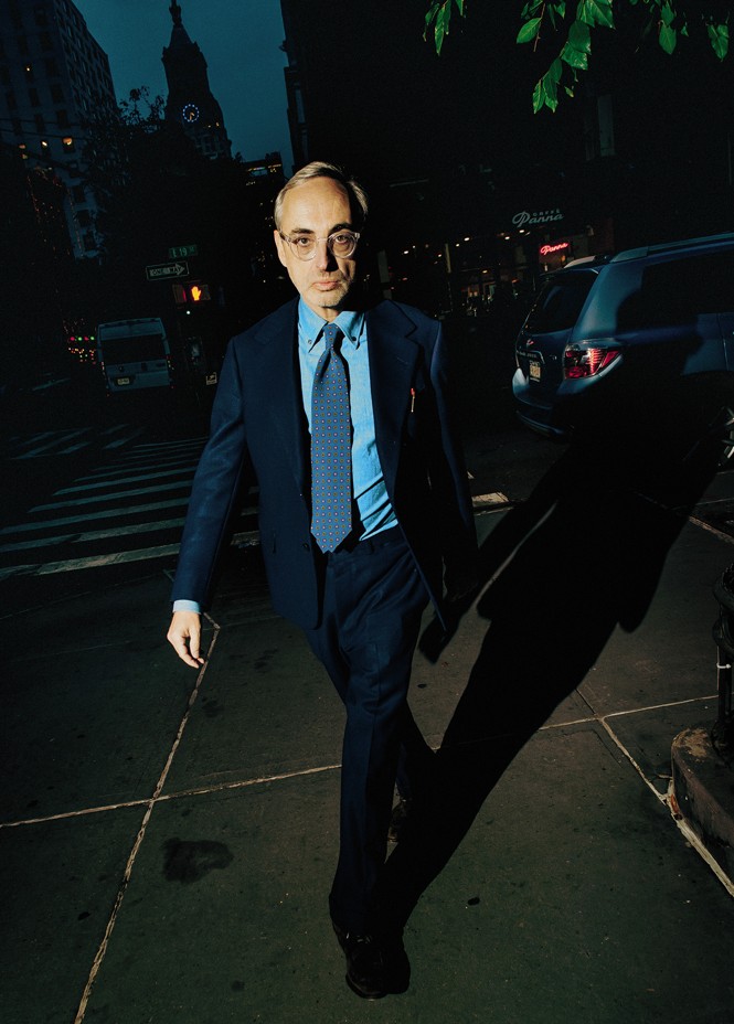 photo of Gary striding down the sidewalk at night wearing the suit