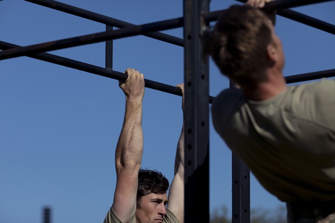 1st Lt. Kevin Moore (left) and 1st Lt. Griffin Hokanson, from the 75th Ranger Regiment, do chin-ups at Doughboy Stadium during the second day of the Best Ranger Competition at Fort Benning in Columbus, Georgia April 12, 2025. 