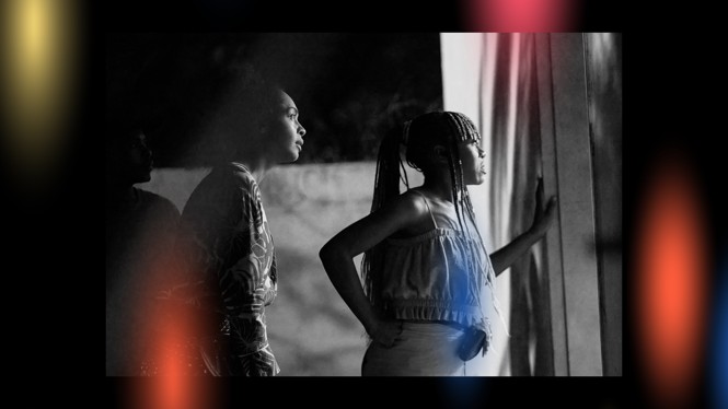 two people looking out of a window