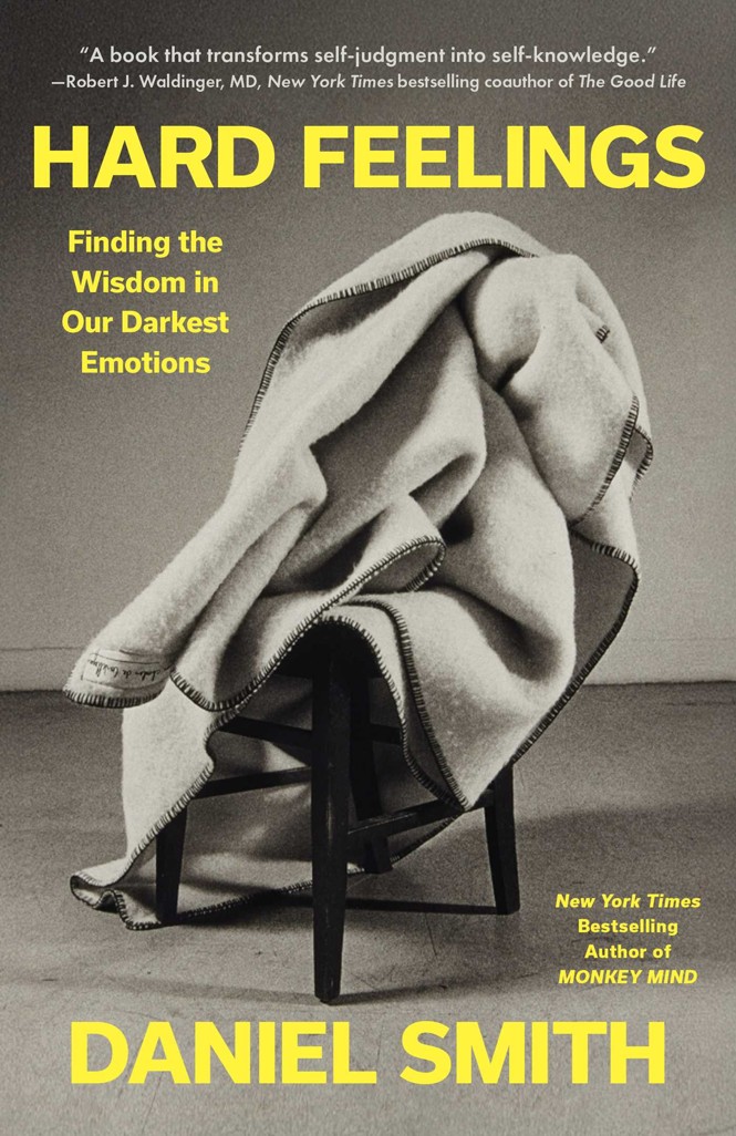 The book cover for Daniel Smith’s forthcoming book, Hard Feelings: Finding the Wisdom in Our Darkest Emotions, which features a chair with a blanket messily draped over it.