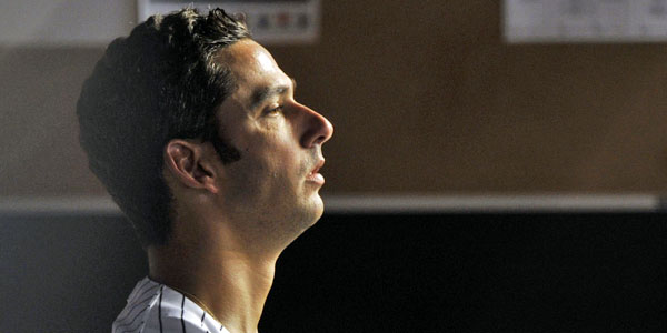 Closeup portrait of New York Yankees Jorge Posada with son at Yankee