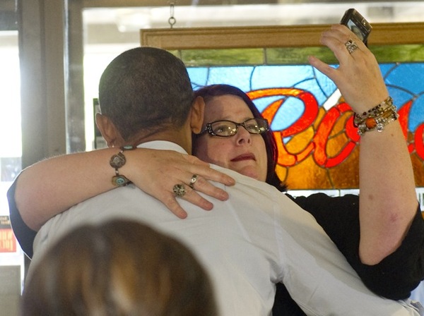 Woman taking photo hugging Obama - AFP Getty - embed.jpeg