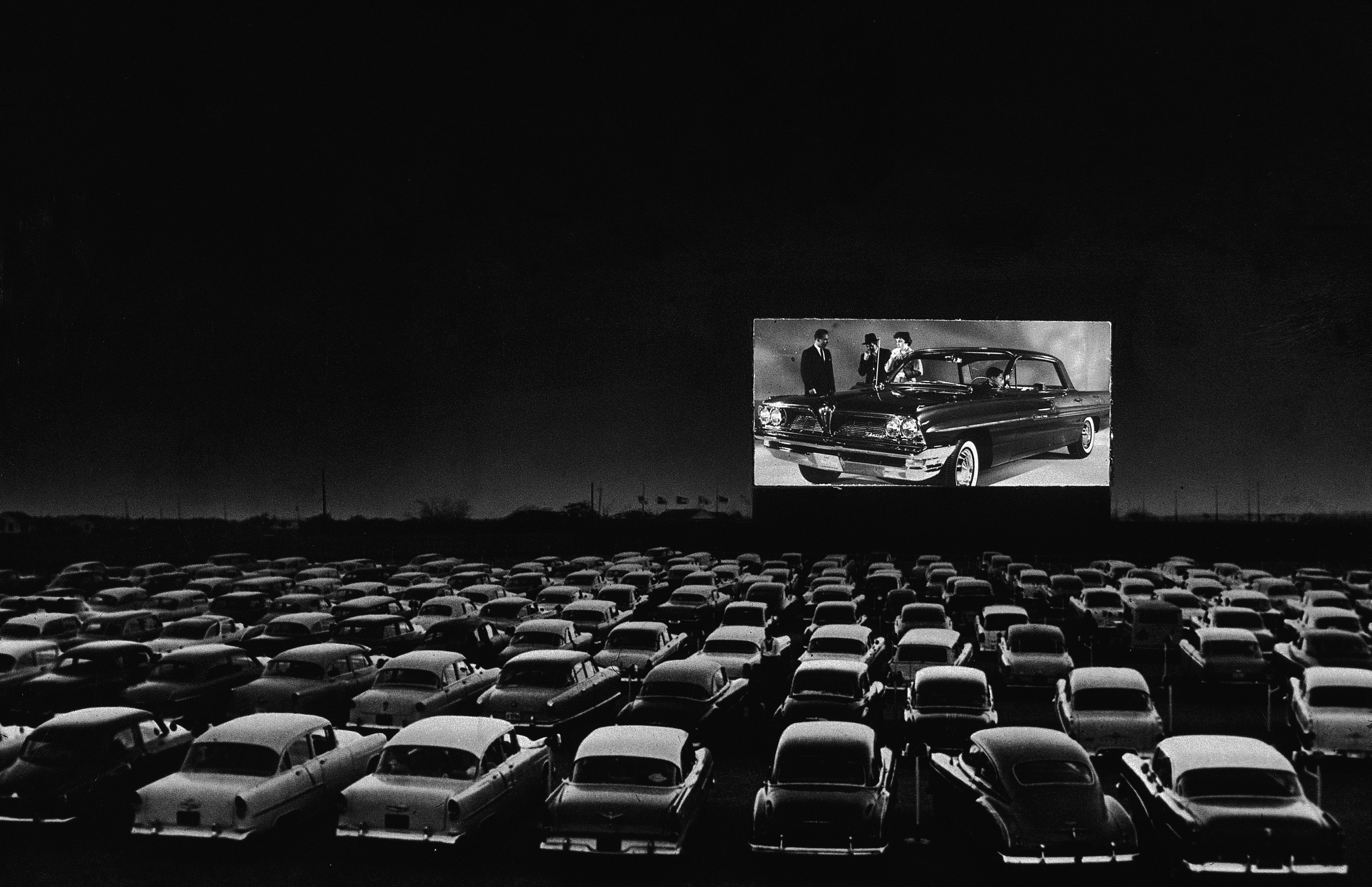 Black-and-white photo of a drive-in theater