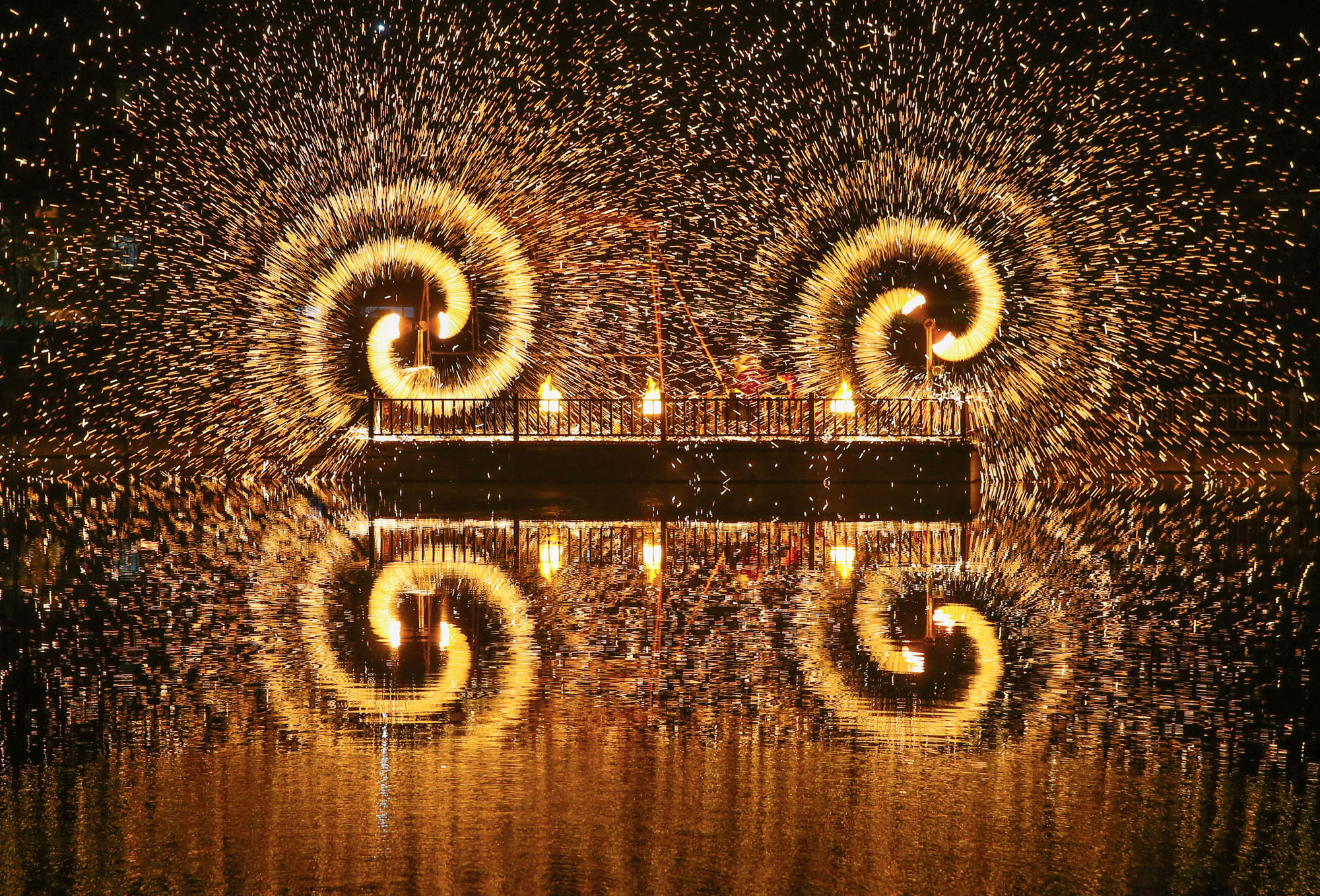 A fireworks display throws off spirals of sparks at Yuwan Scenic Spot in Lianyungang, in China’s Jiangsu province.