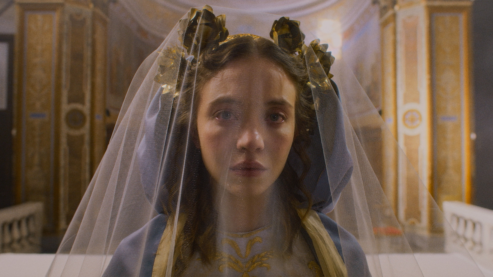 Sydney Sweeney crying under a veil in a still from her new movie, Immaculate