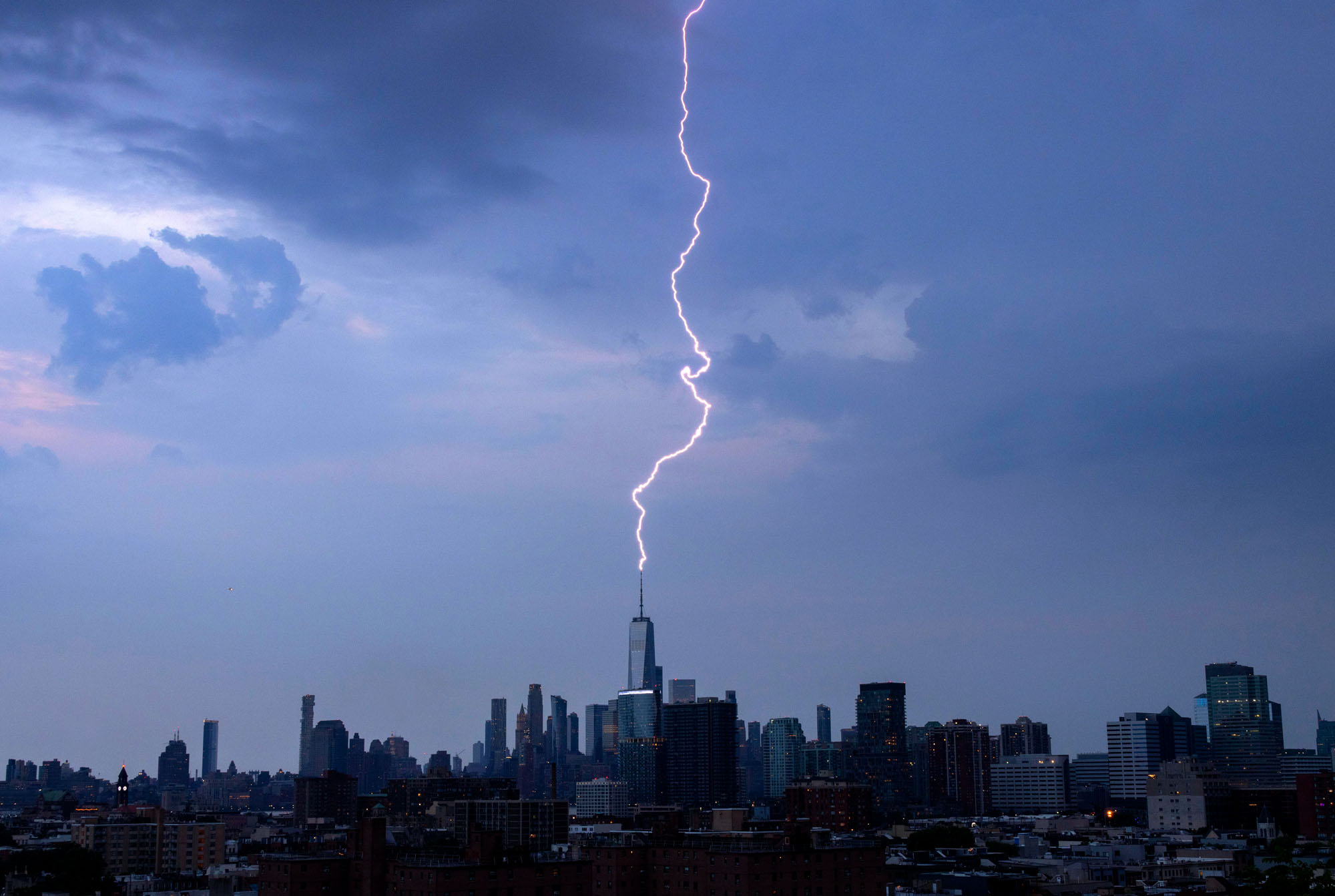 A lightning bolt strikes One World Trade Center during a thunderstorm in New York City.