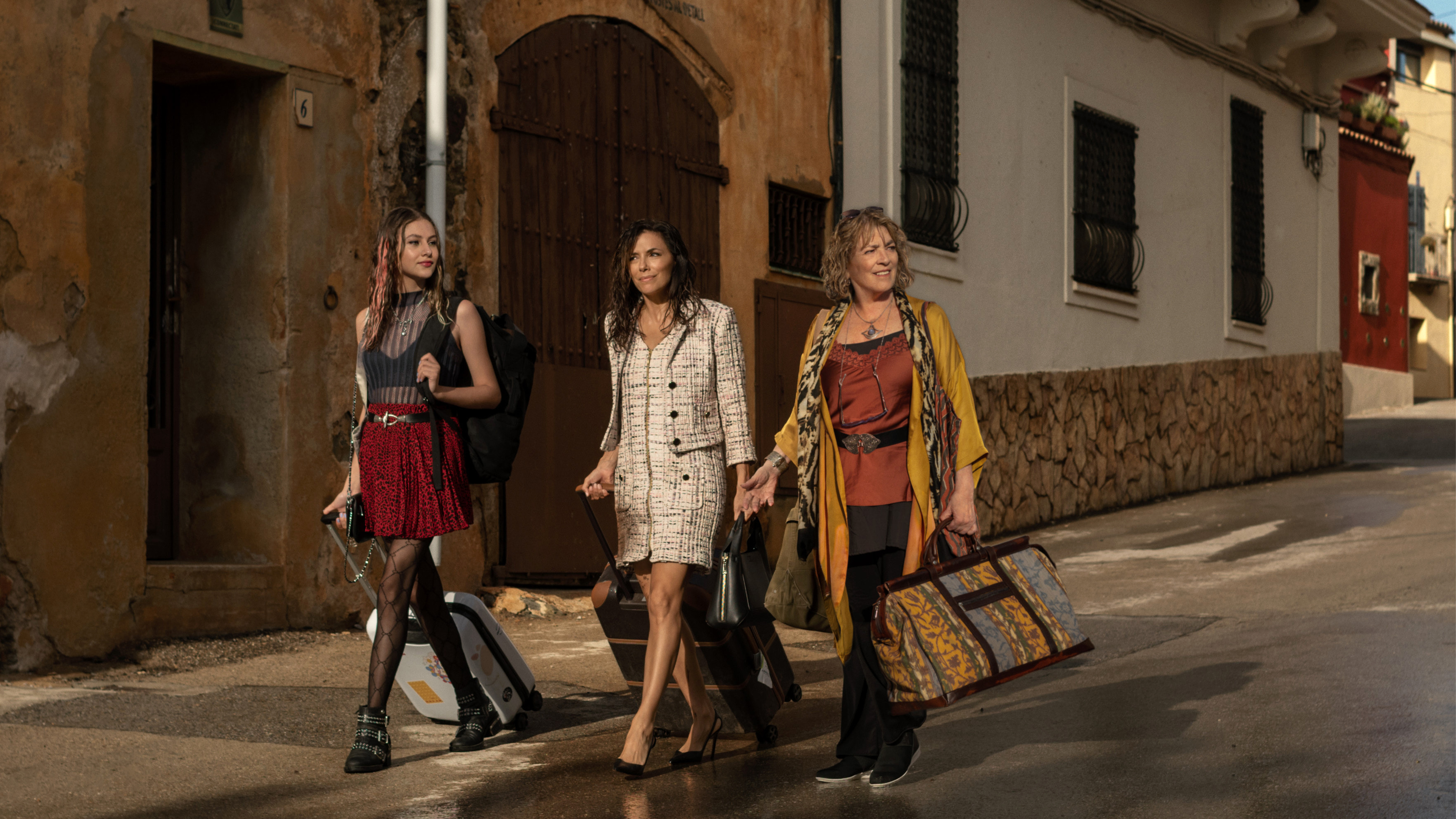 Eva Longoria walking with a suitcase in a still from the Land of Women series